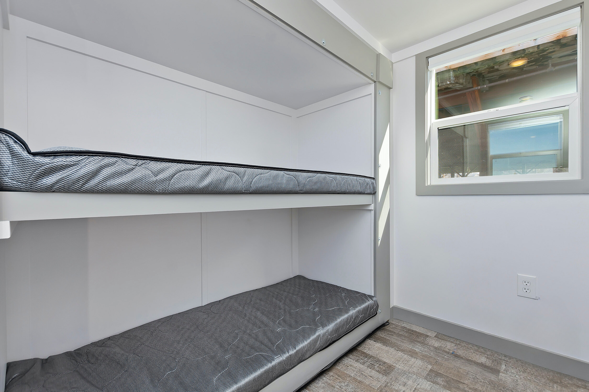 Bunk beds in kids room with grey sheets