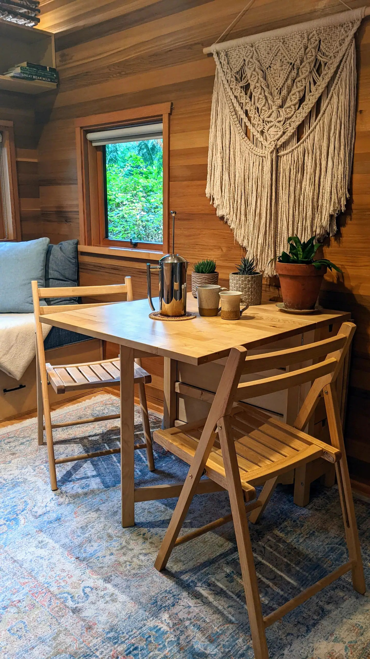 Dining room chairs and one desk, made of wood with a coffee and flowers on it