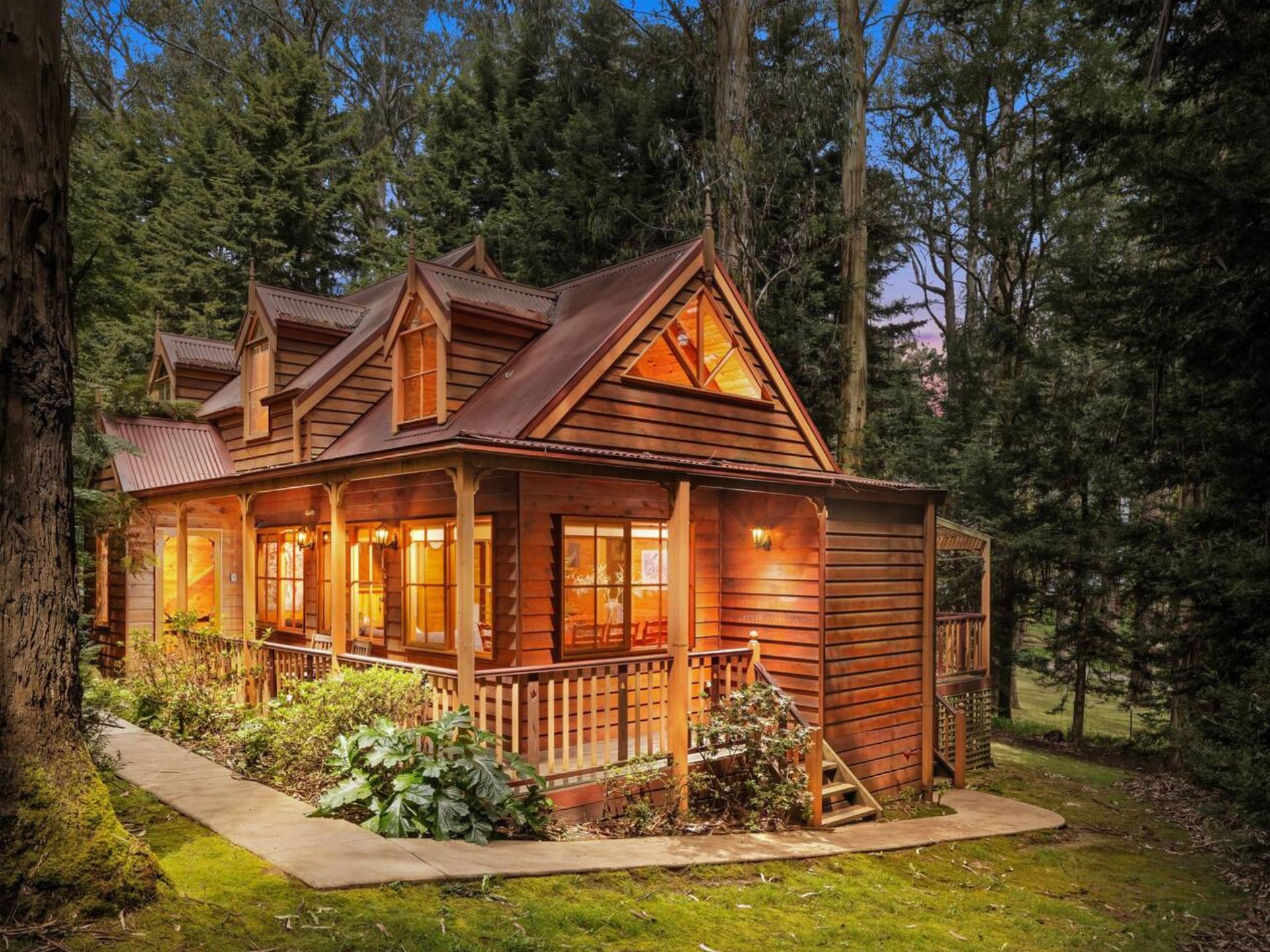 Wooden cottage in the forest, surrounded by tall trees