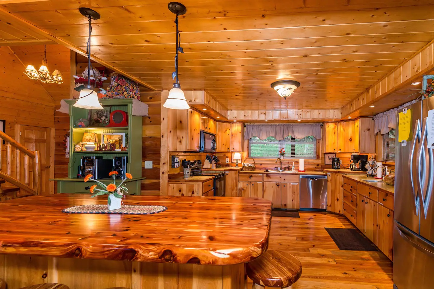Fairytale Log Cabin kitchen made of wood with green cabinet