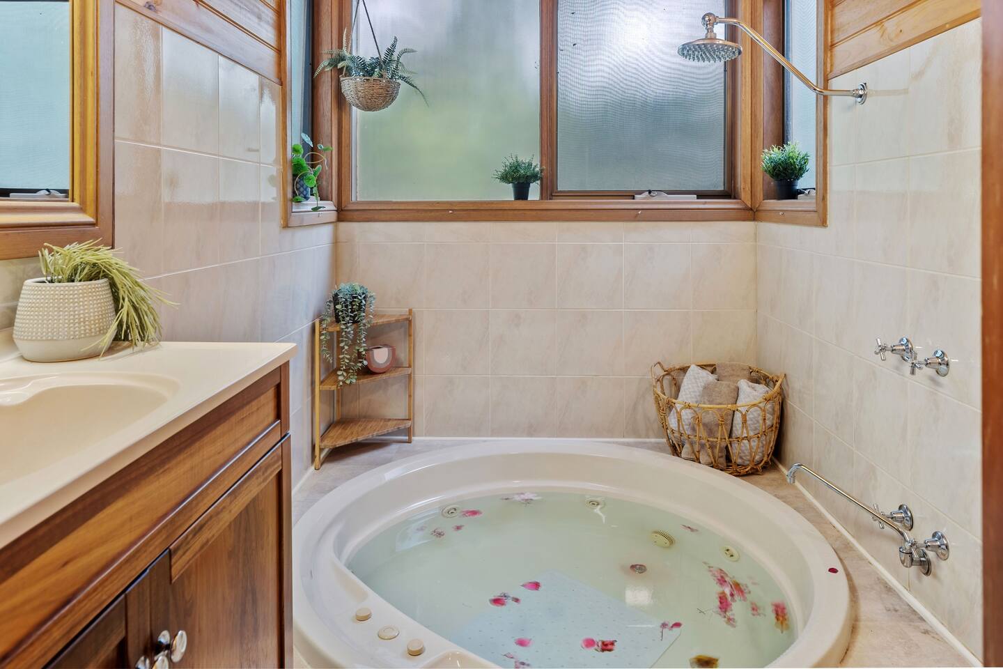 Hot tub in bathroom with rose flowers in water