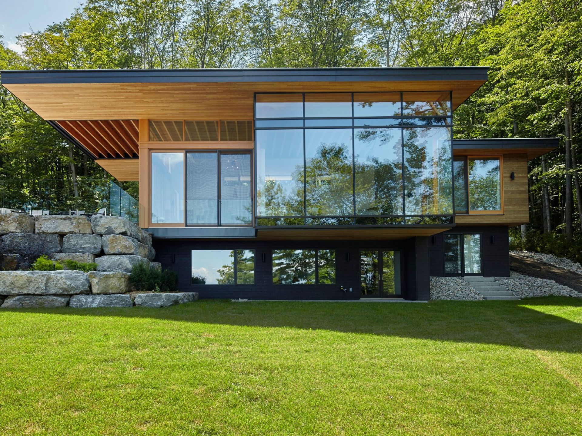 Modern house surrounded by nature, with a lot of windows