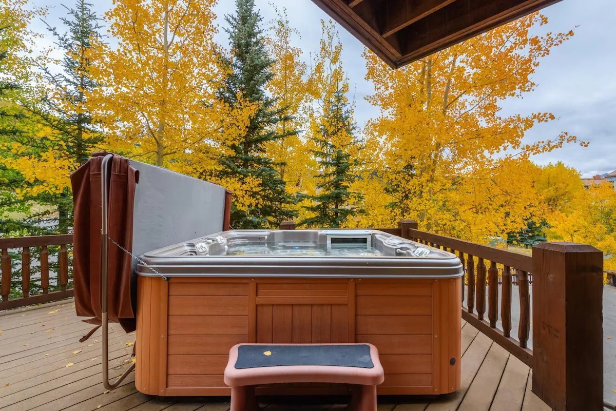 Jacuzzi on the terrace surrounded with wooden fence