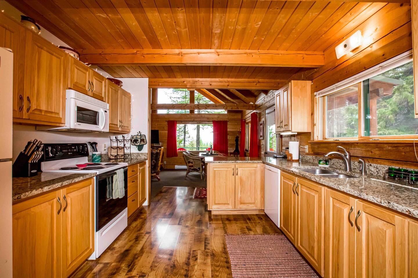Kitchen made of wood with sink near large window