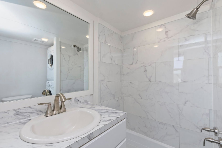 Marble tiles in toilette with a large mirror