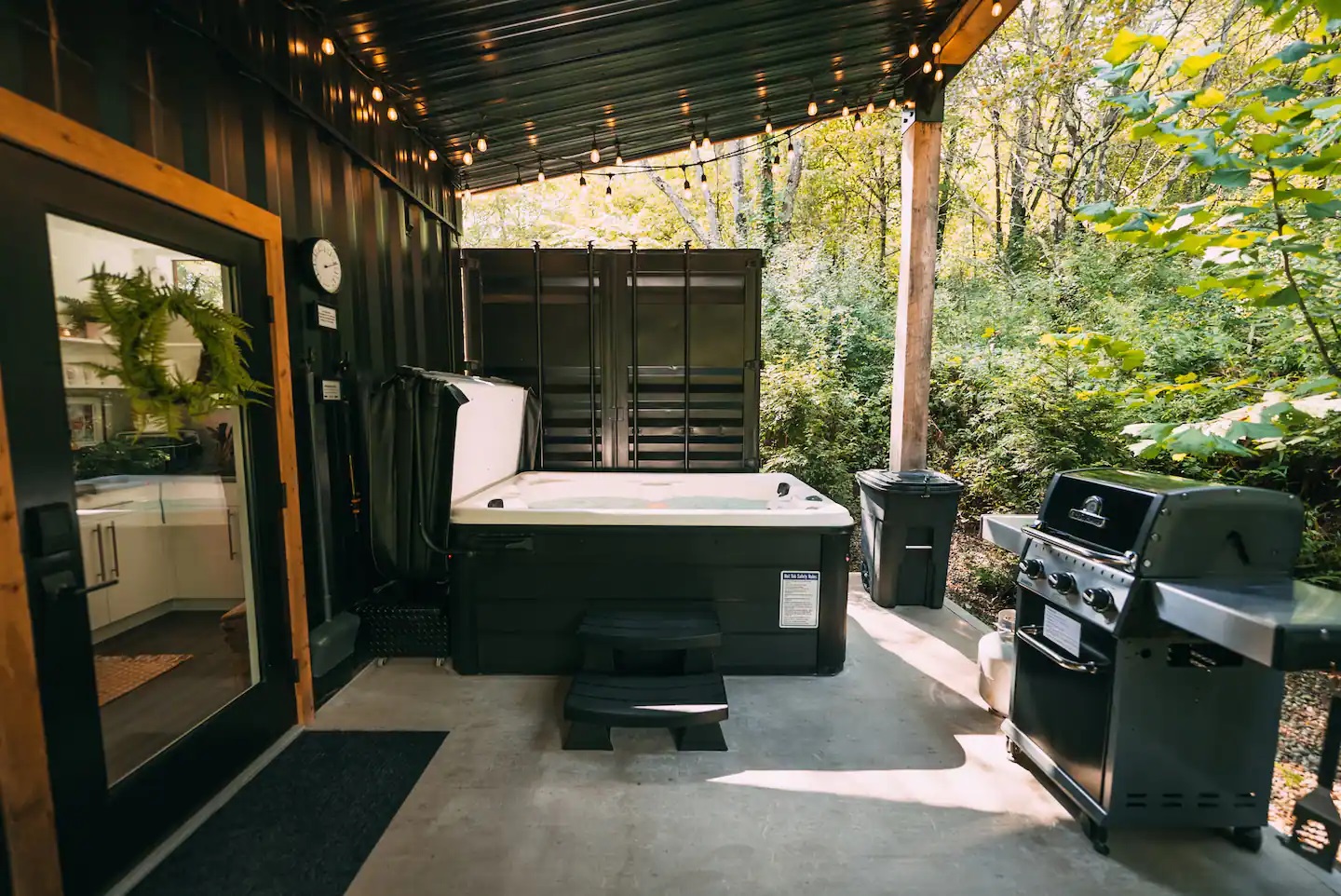 Hot tub and grill on porch in front of door