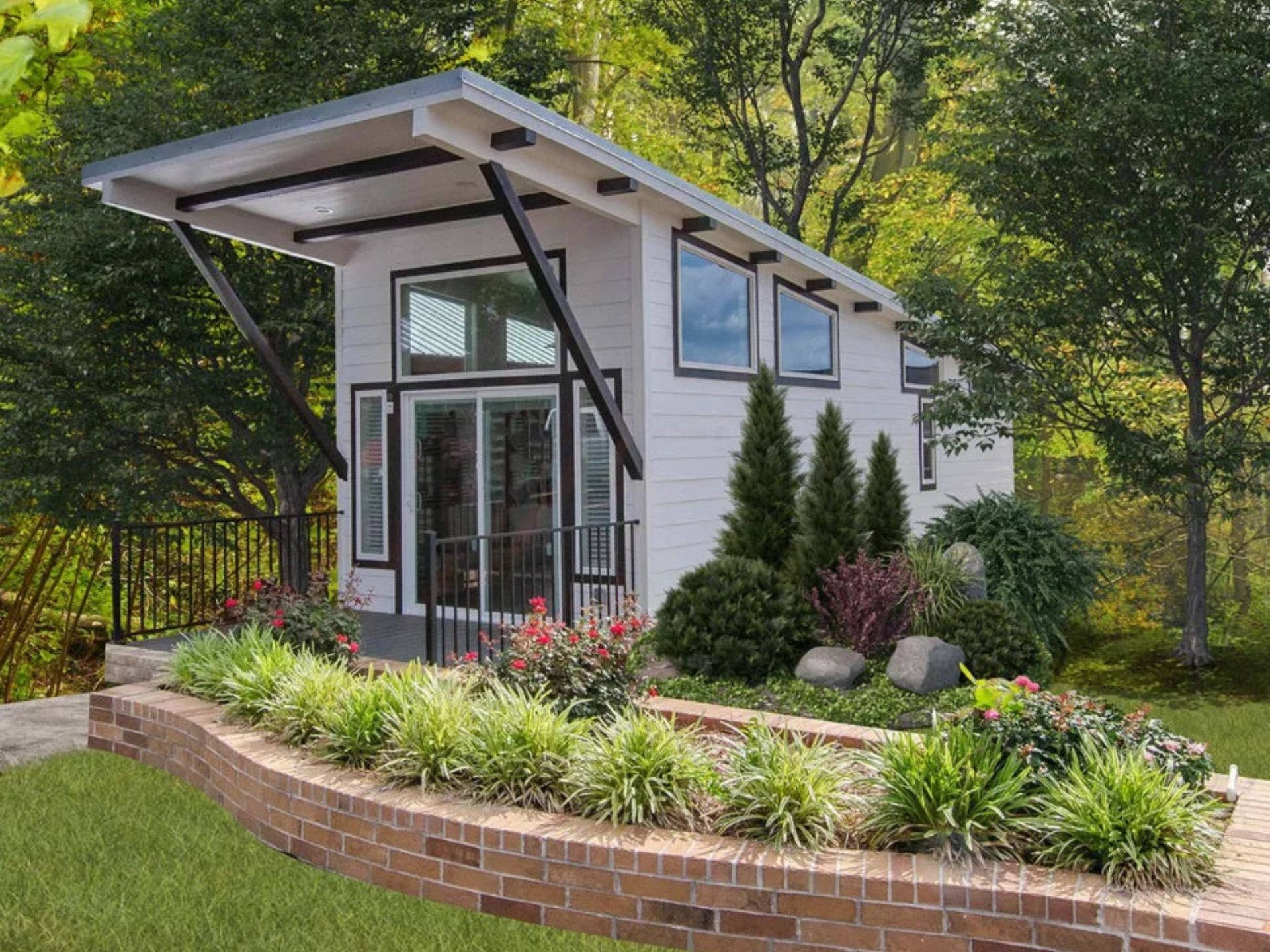 The Huntington tiny home with a beautiful garden in front of it