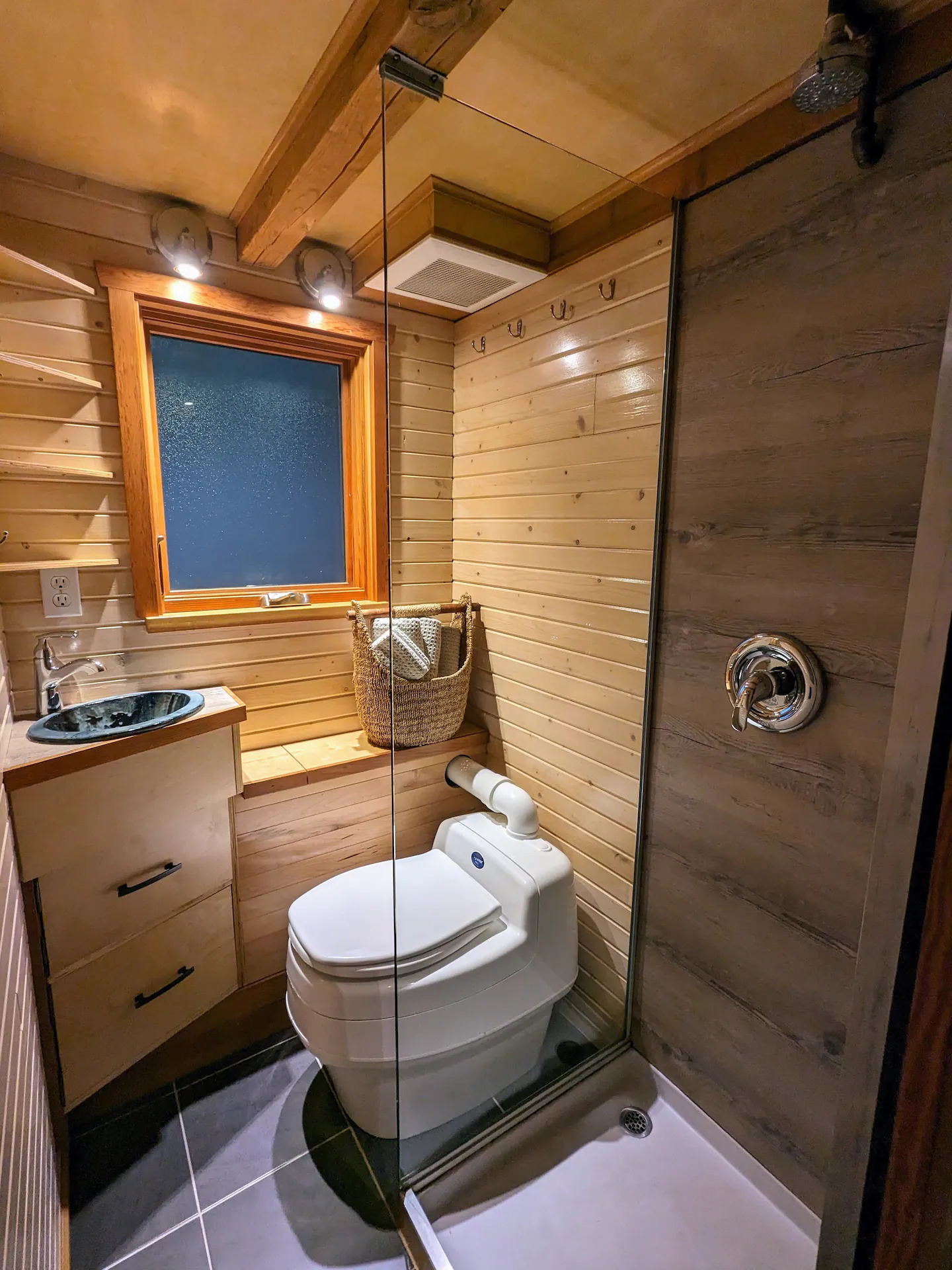 Toilette made of wood, with glass shower