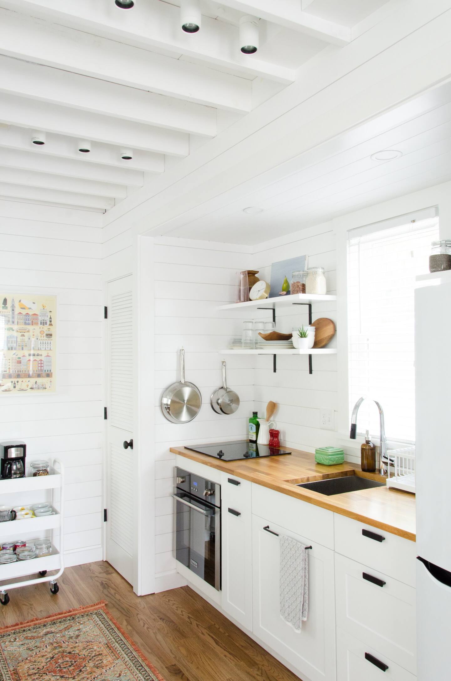White tiny kitchen with small black details