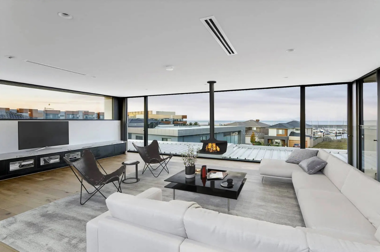 Living room with a beautiful view, floor to ceiling windows, big white couch