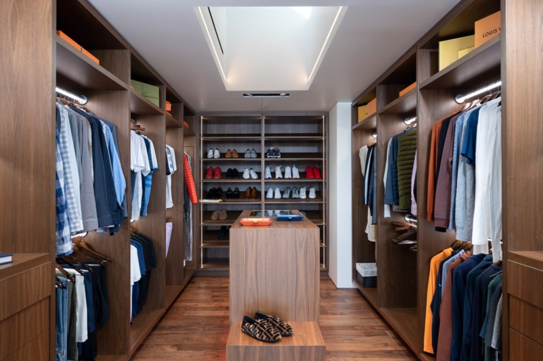 walk-in closet with a lot of clothes and shoes