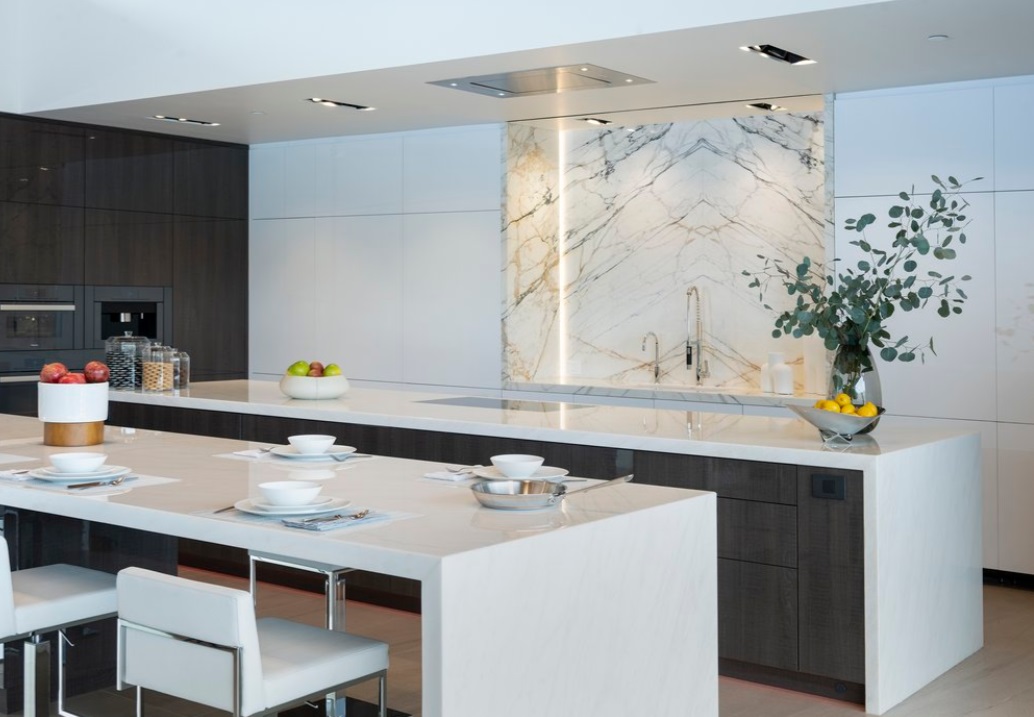 white kitchen with a dining table, marble wall
