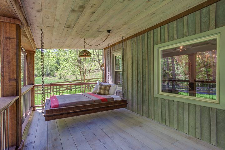 porch of a rustic cabin, hanging bed