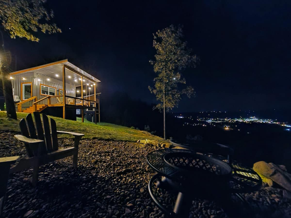 Container home at night with a beautiful view on the city