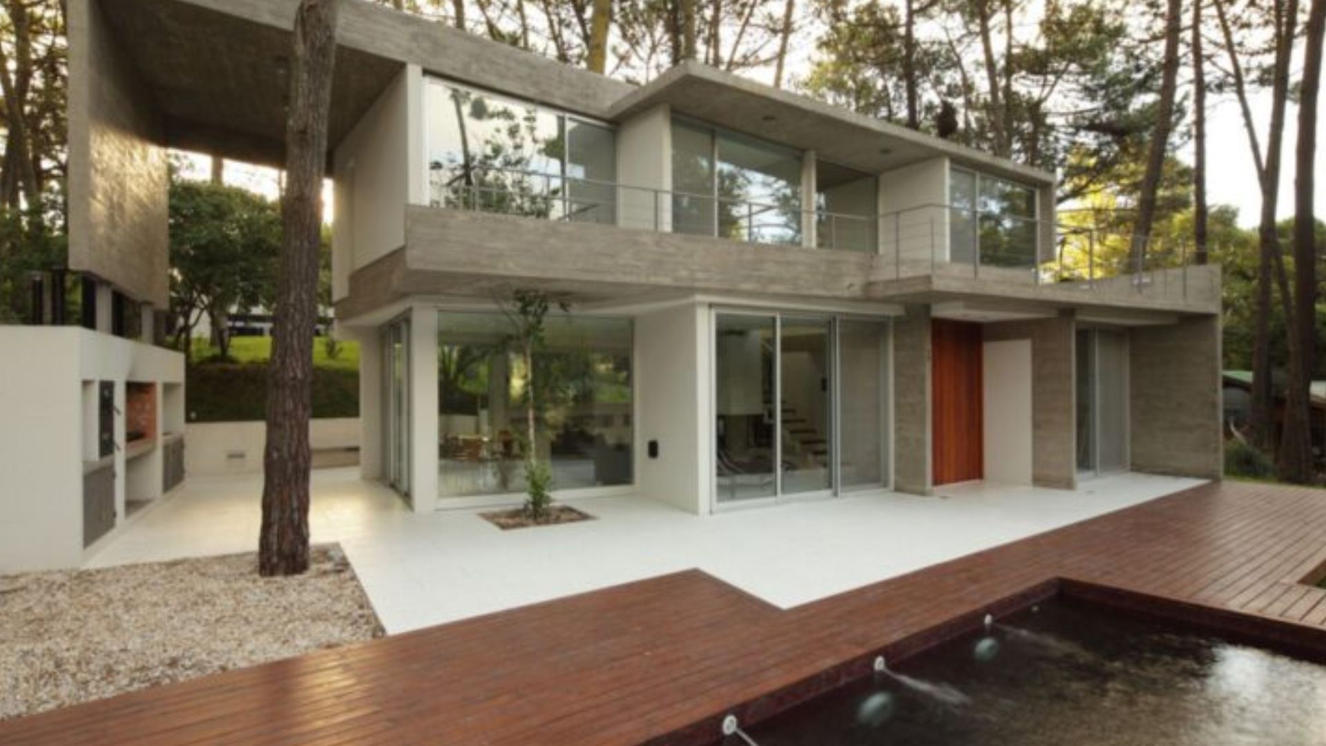 exterior of a modern house with a pool in nature