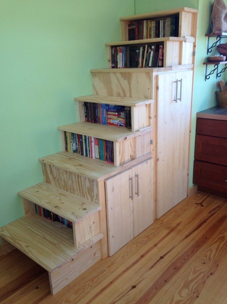 Shelves like a stair, made of wood with a lot of books on them