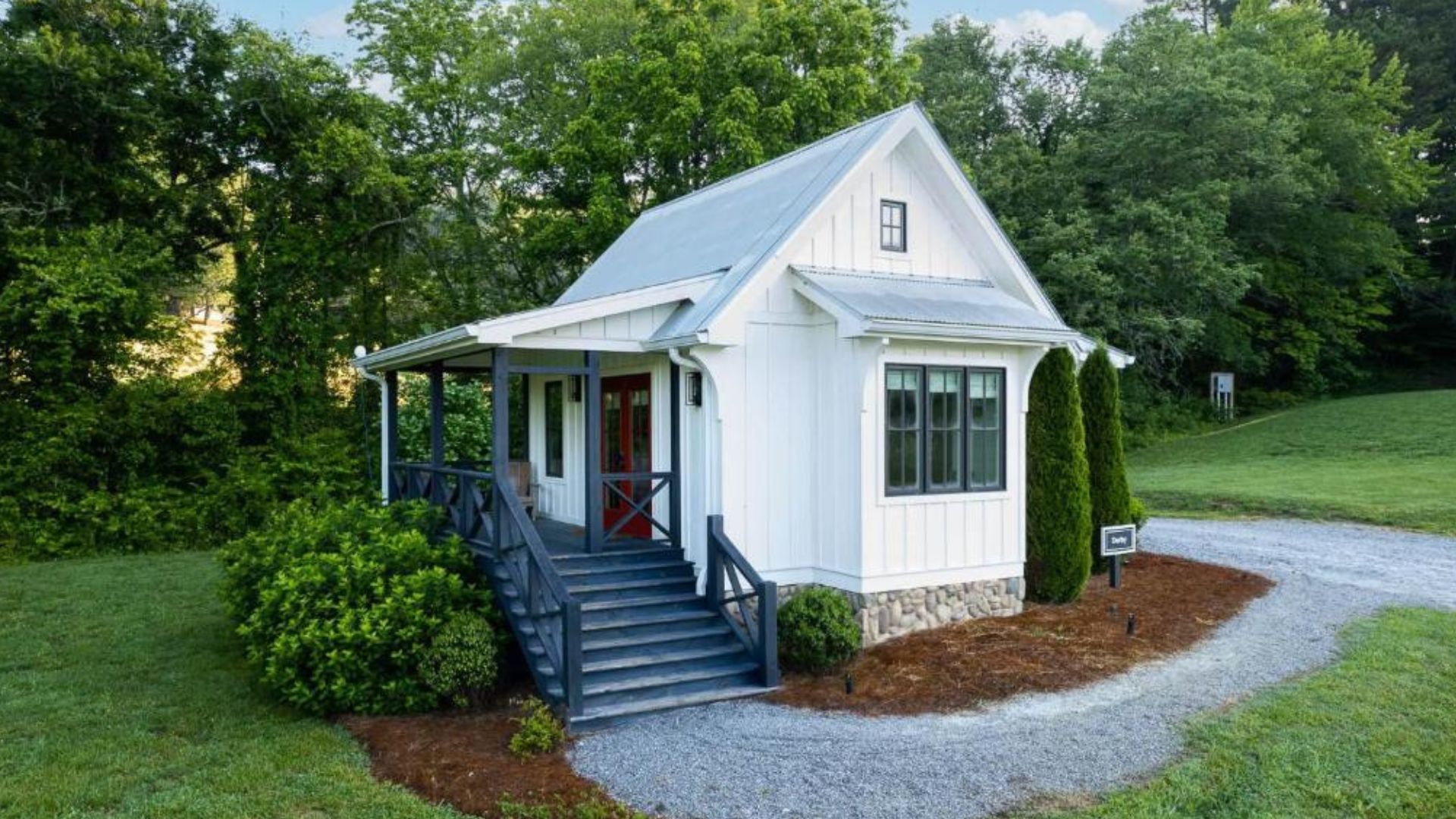 exterior of a house with white walls and greenery around it