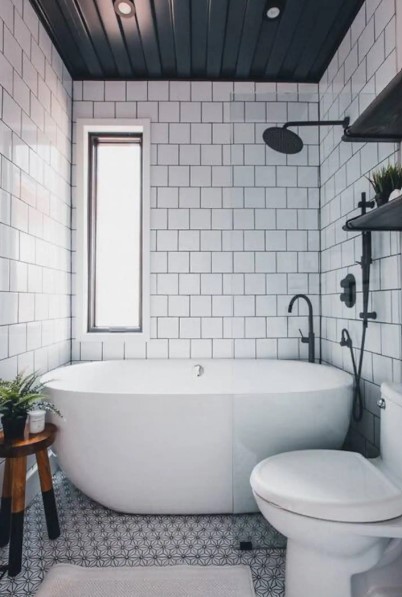 bathroom with white tiles and big bath
