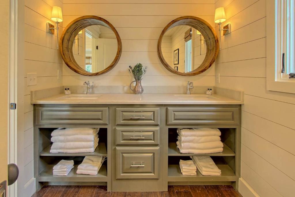 bathroom with an olive green cabinet and two mirrors