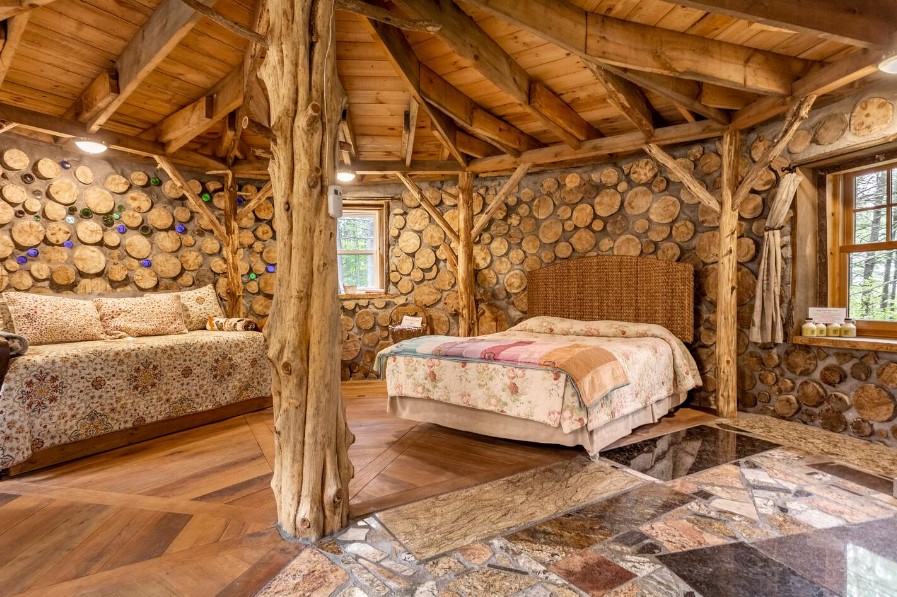 a bed and a couch in a cabin