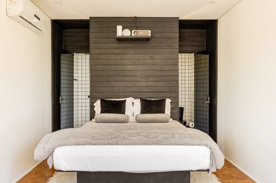 bed with black and white toilets on each side