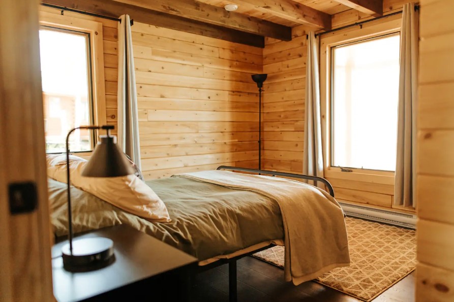 bedroom of a cabin facing a window