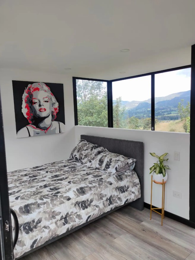 bedroom with a bed and a marilyn monroe picture on the wall
