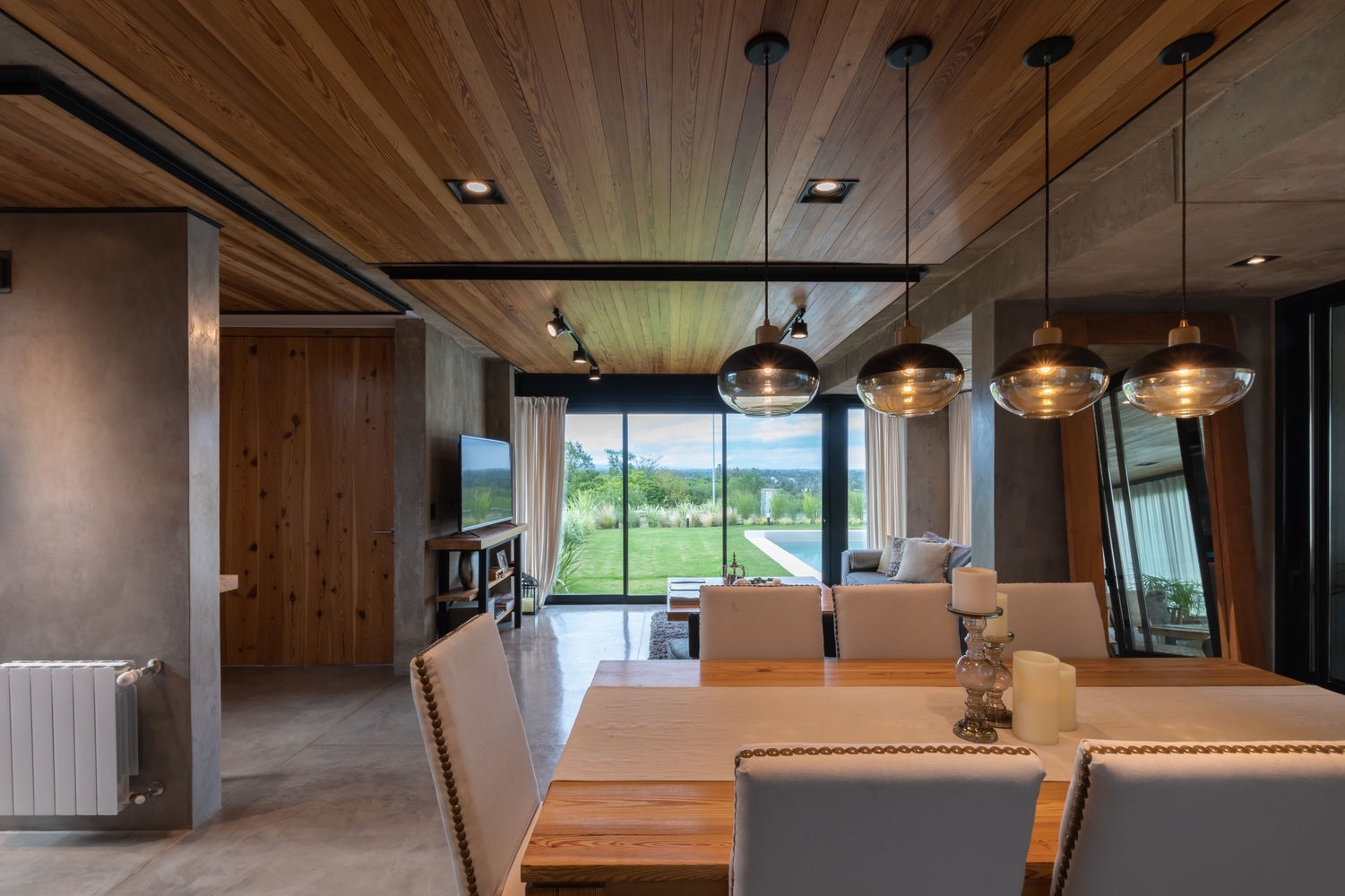 dining table with white chairs around, overlooking the living room