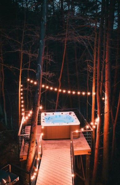 jacuzzi outside surrounded by fairy lights