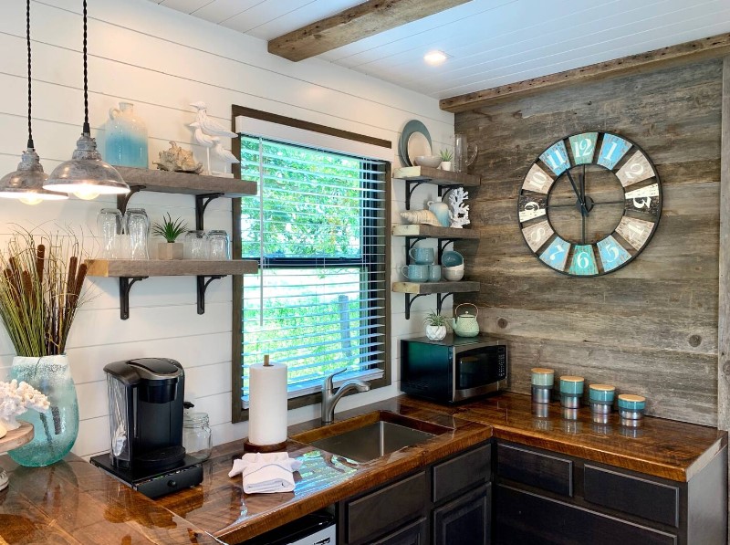 kitchen with shelves with shell decor and blue and white amenities