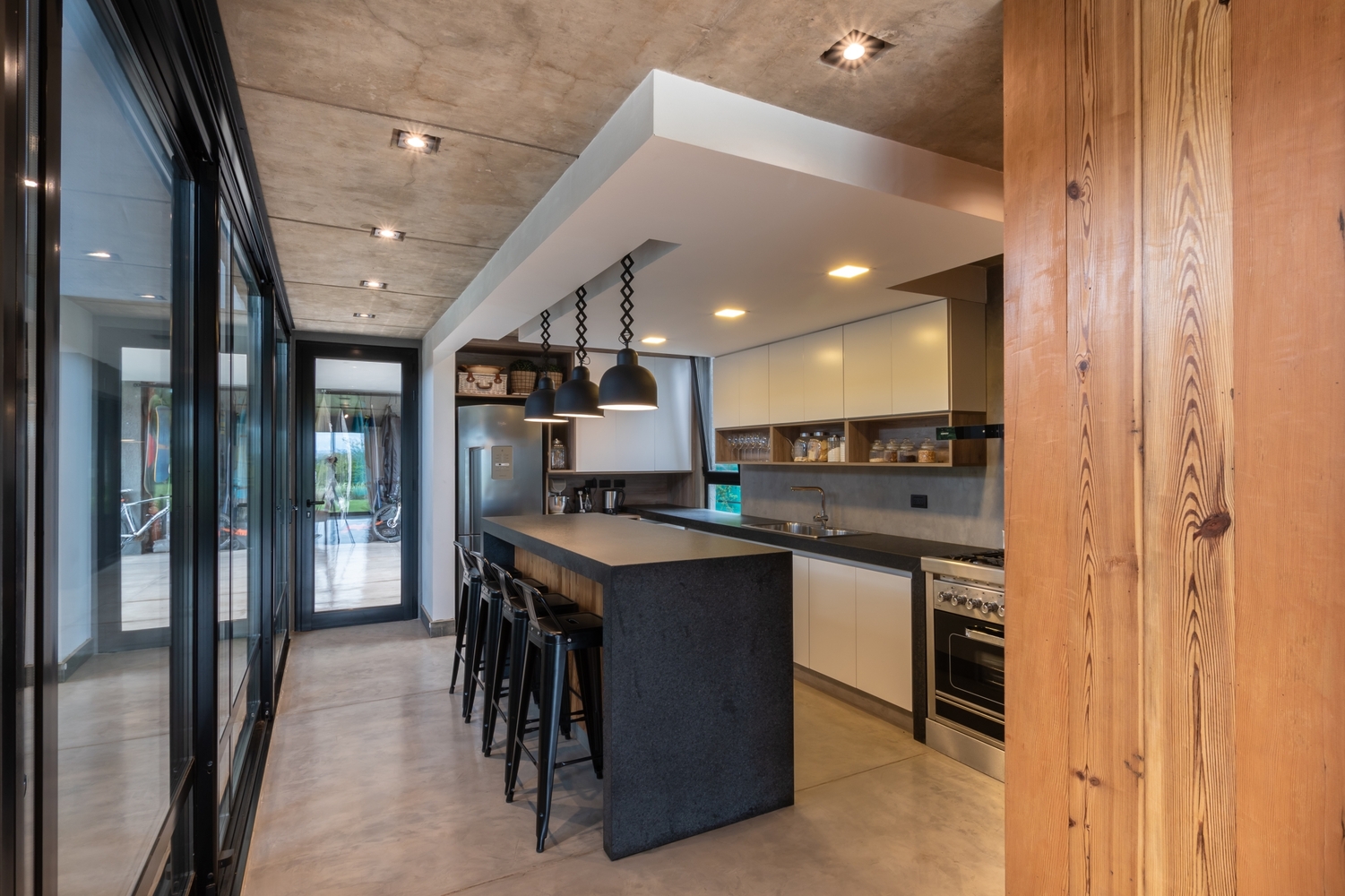 kitchen with white cabinets and black countertop and island