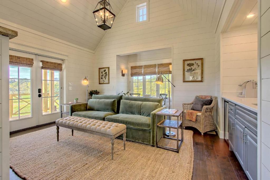 light green couch and beige carpet of a living area with white walls