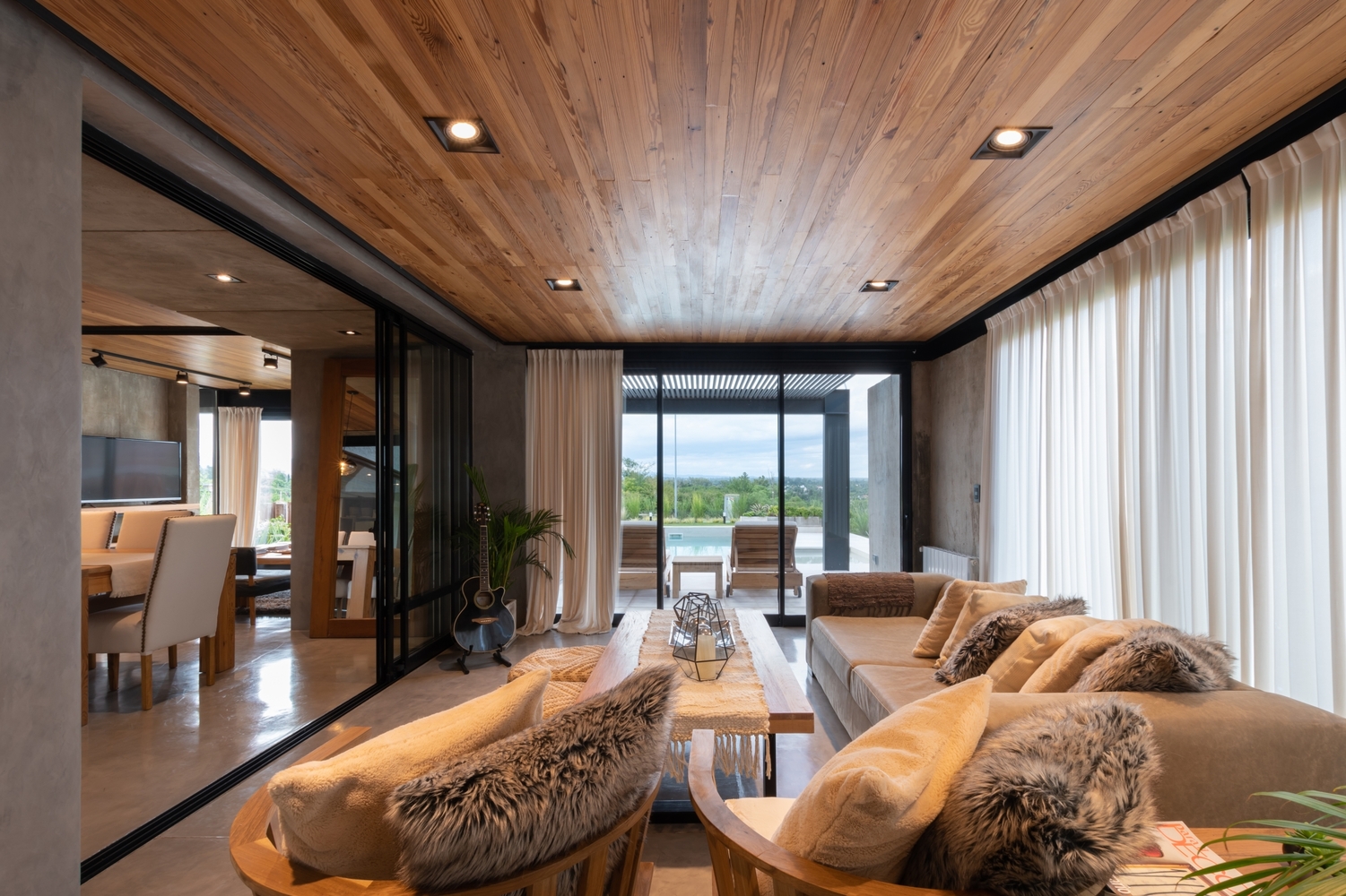 living room with a light gray couch and floor to ceiling windows