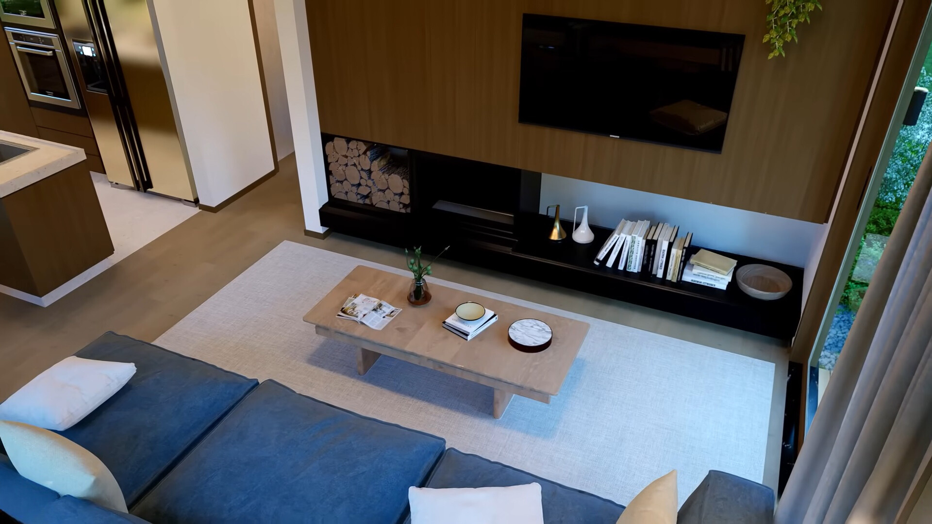 living room with a flat screen tv, black cabinet and fireplace