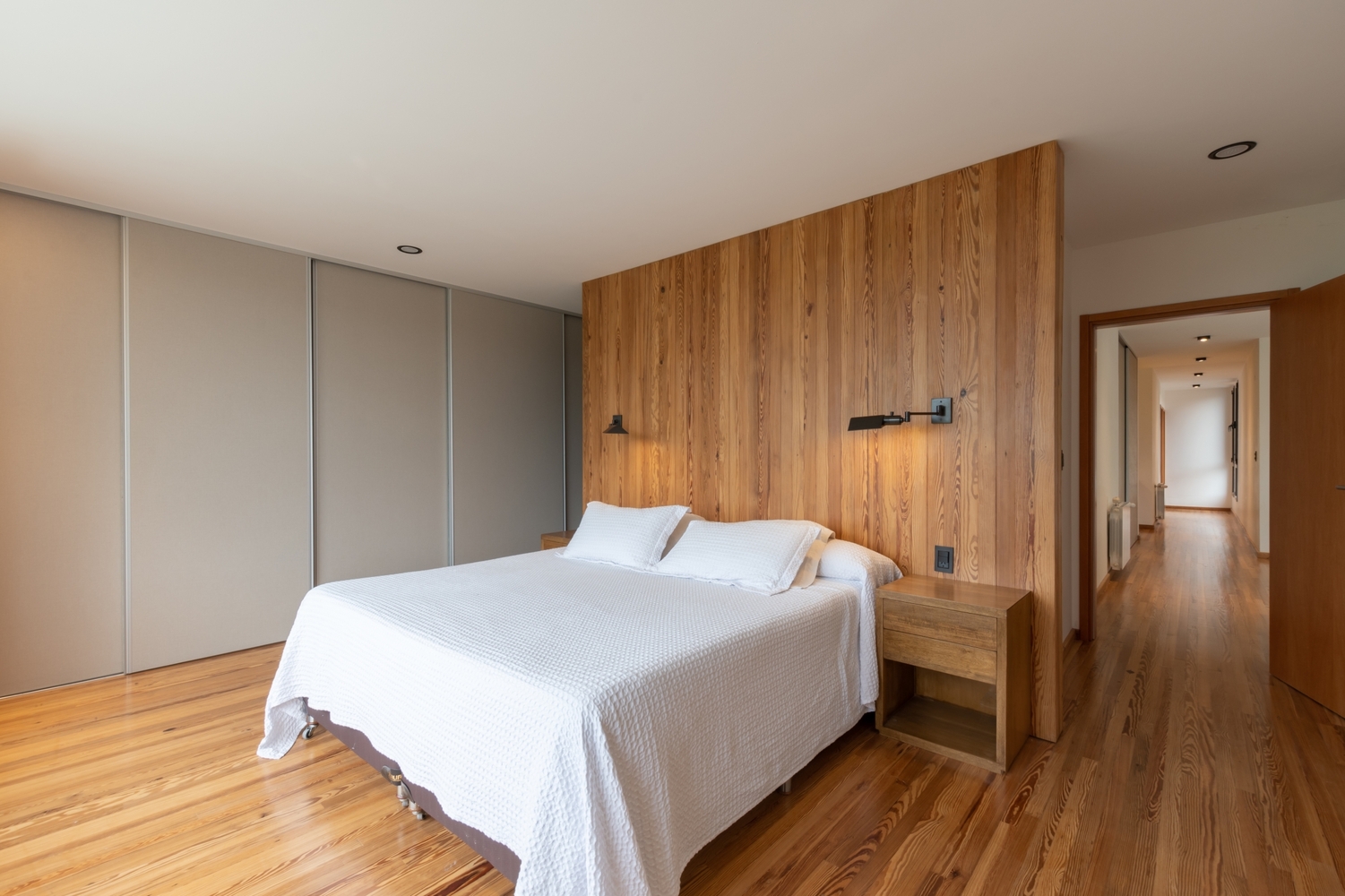 minimalist brown and white bedroom with a bedside table