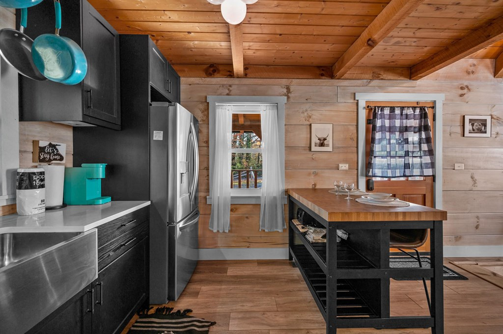 black cabinets and brown countertop in a cabin with a brown dining table