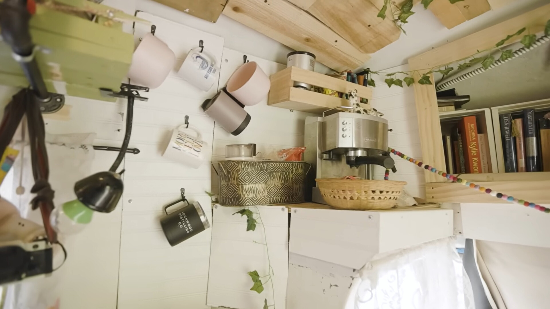shelves and hooks with mugs, books and a coffee machine