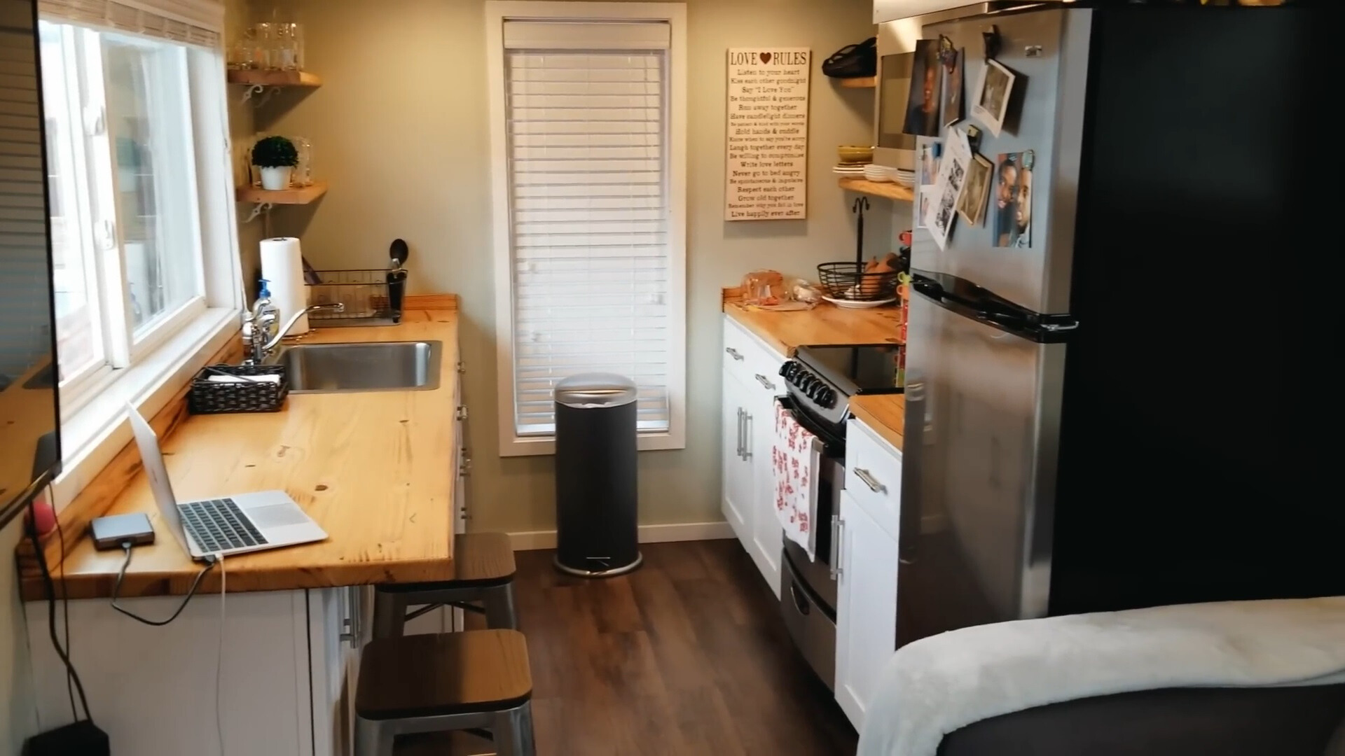small kitchen with a brown countertop and a big window