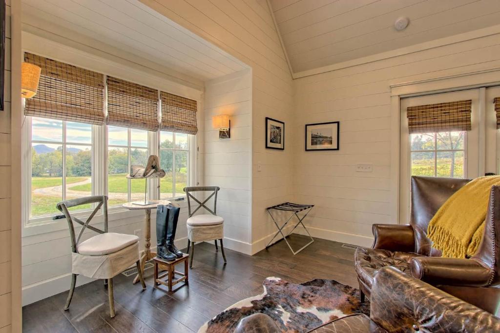 small table and two chairs next to a window