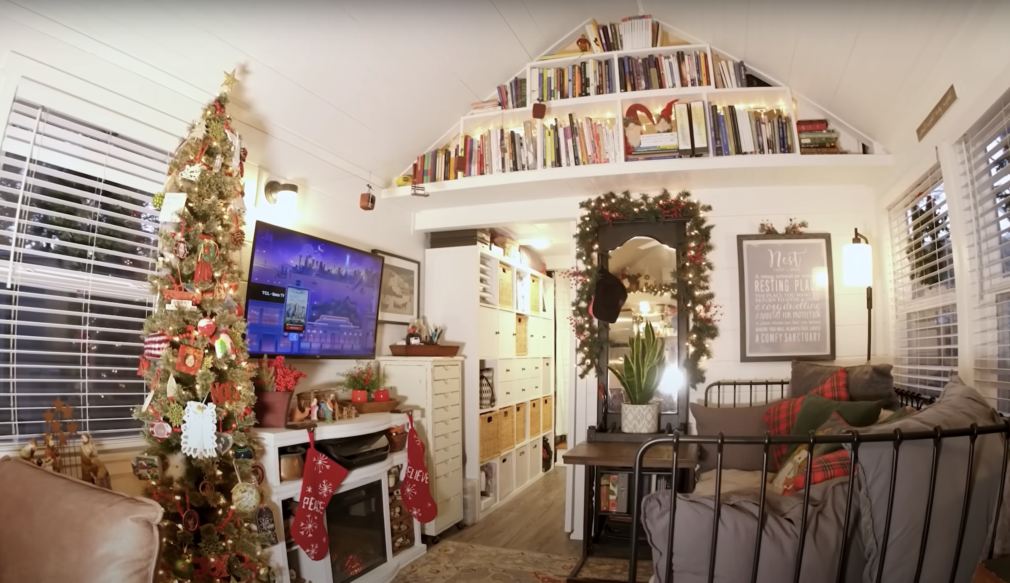tiny house living room with Christmas tree and book shelves