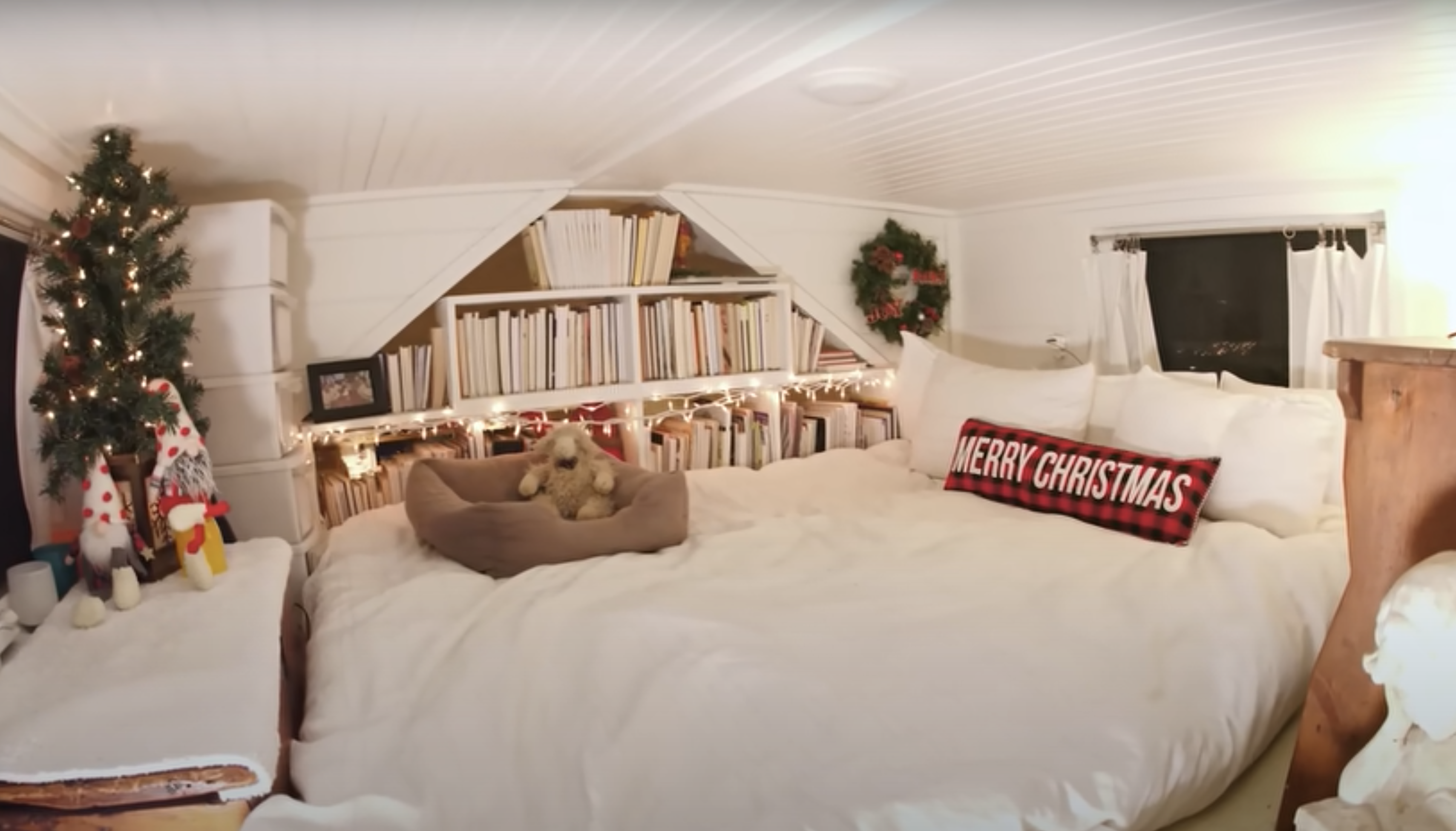 tiny house loft bedroom with decorations and book shelves