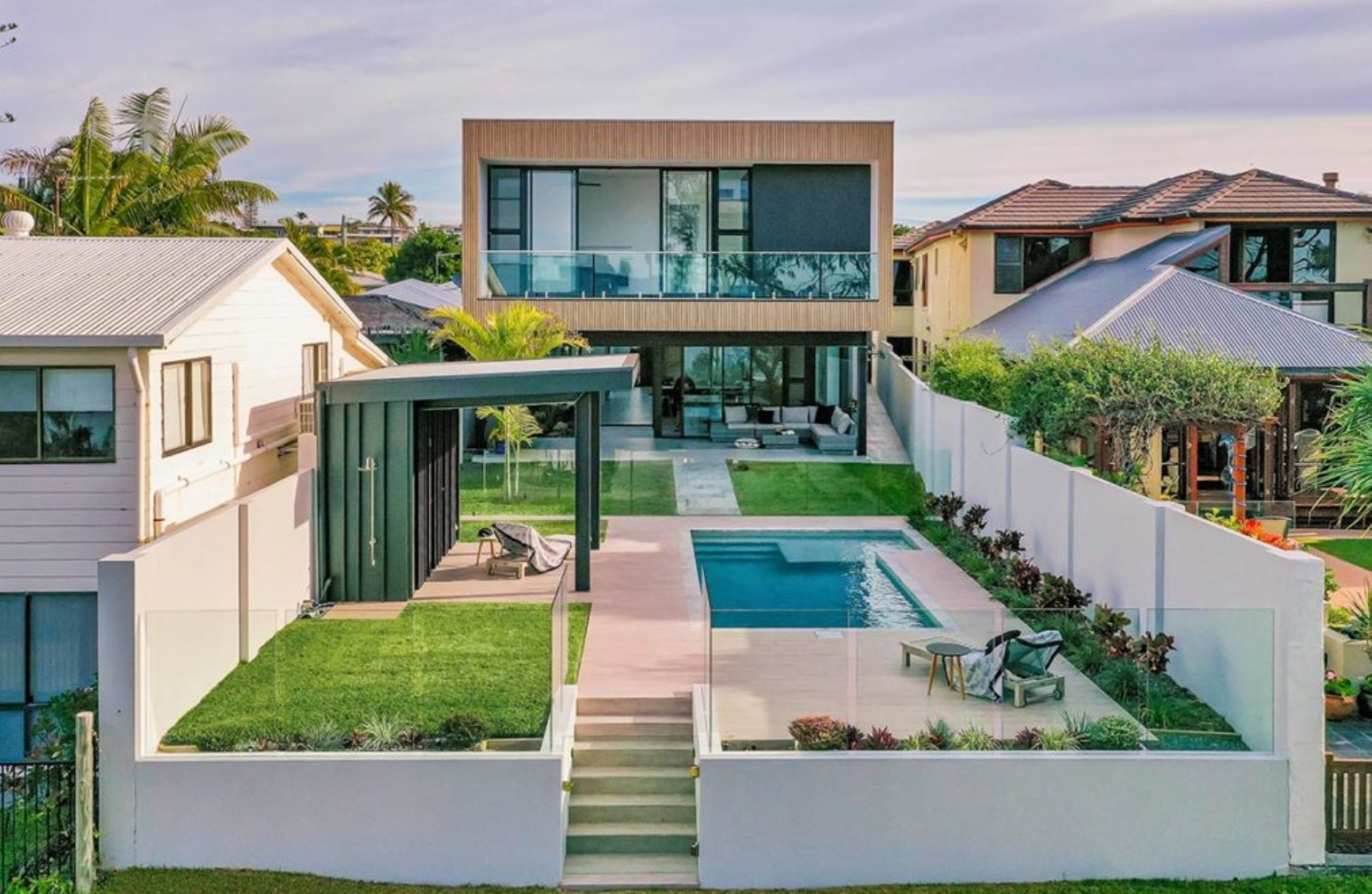 Backyard of modern home with greenery and a pool