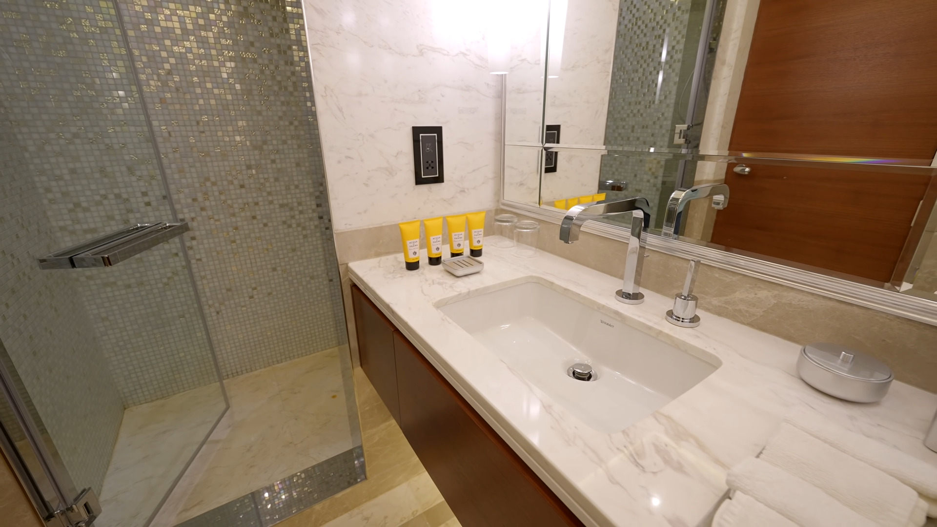 Bathroom with a mosaic shower and a floating marble sink