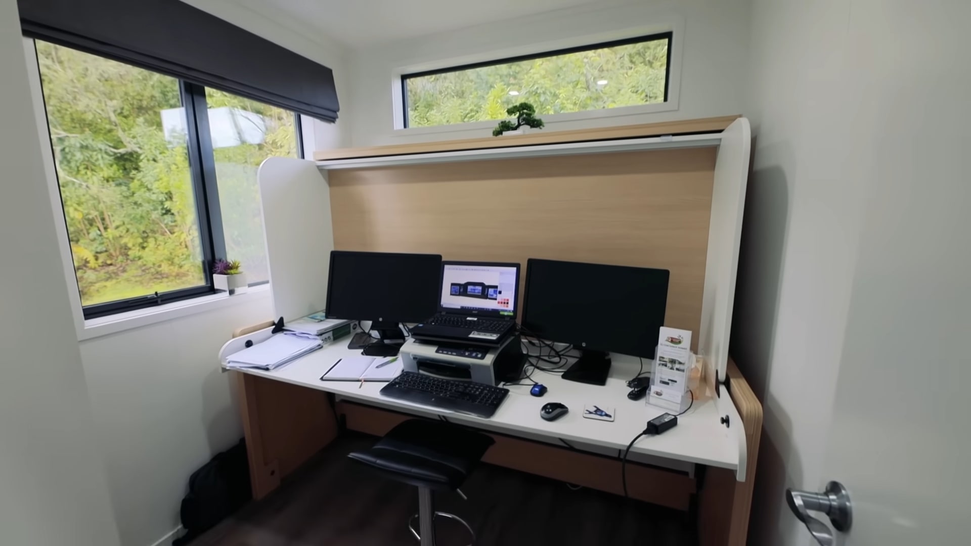 A bedroom with a desk that converts into a bed