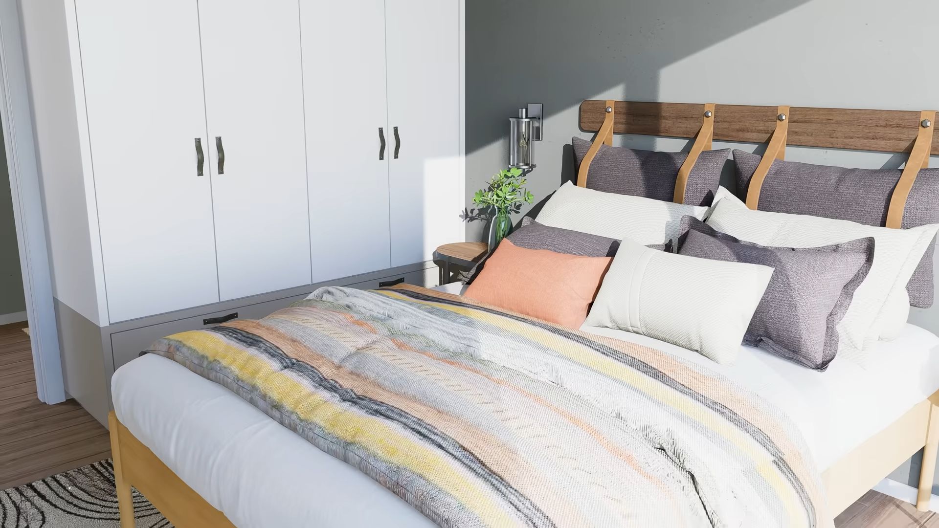 Bedroom with a colorful throw blanket, a lot of pillows and a white wardrobe