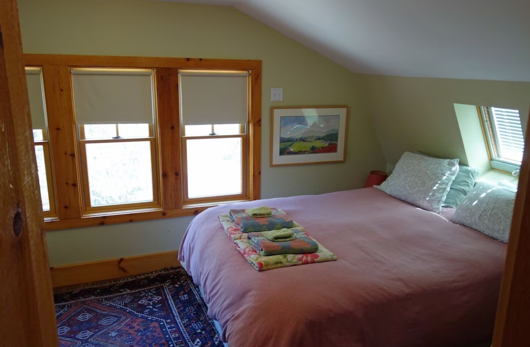 Bedroom with windows and a queen sized bed