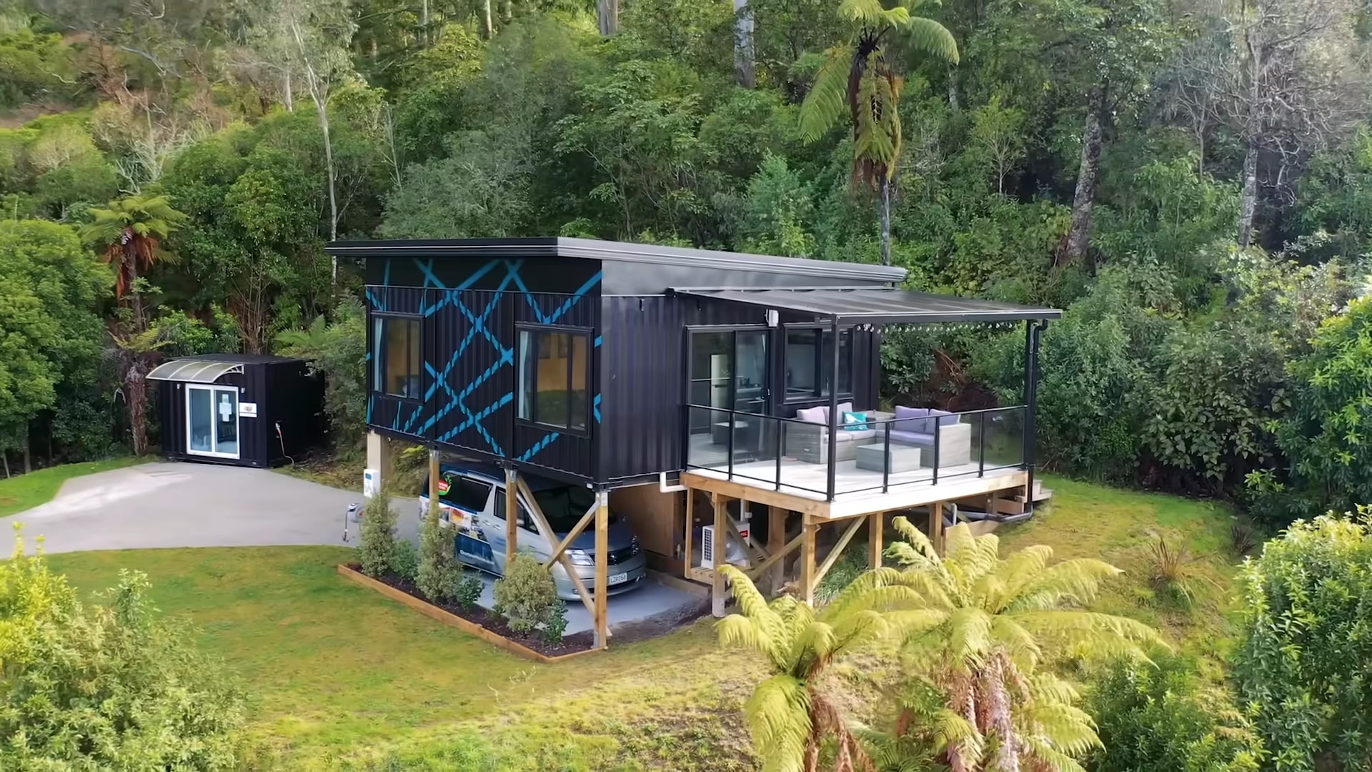 Elevated container home with a deck and carport