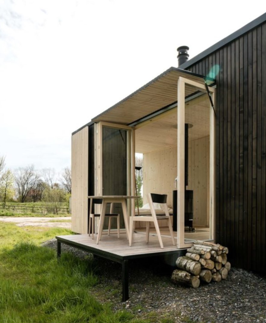 Deck area of Container home with a table and chairs