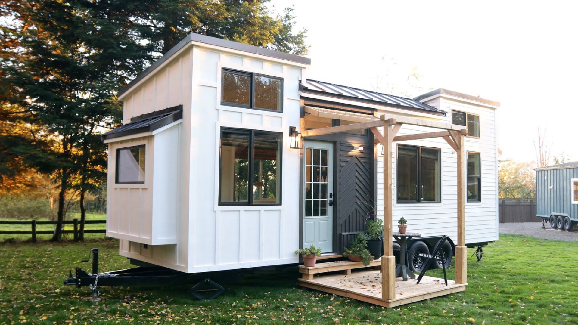 exterior of a tiny home with light blue door and a porch