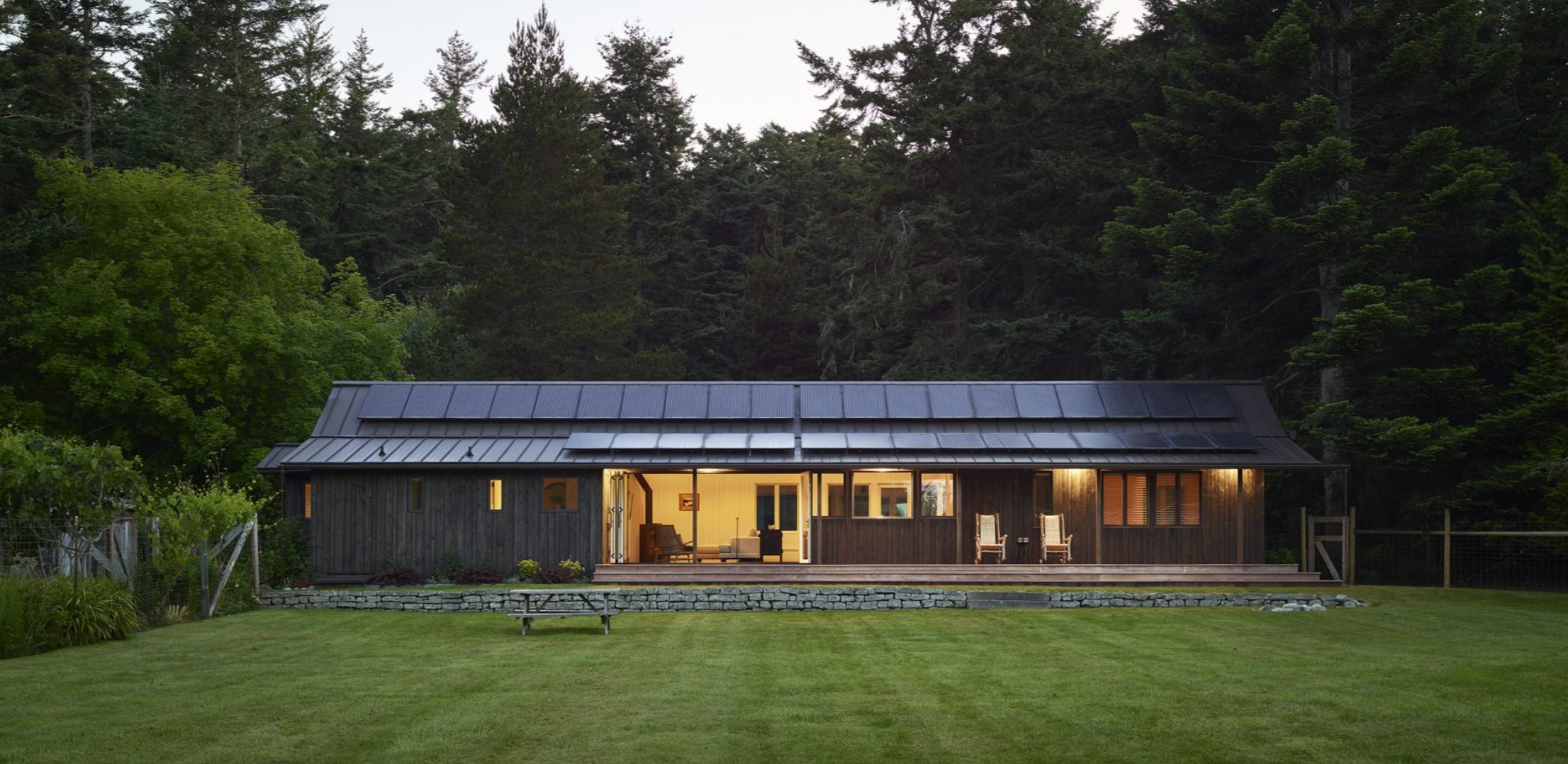 Exterior of a cabin with a backyard and a small table